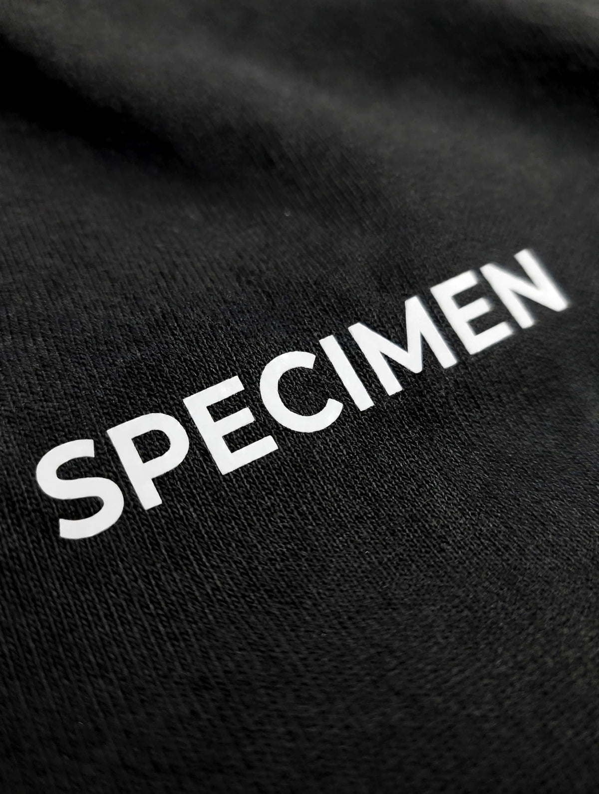 Doers Club black tee cotton texture detail
