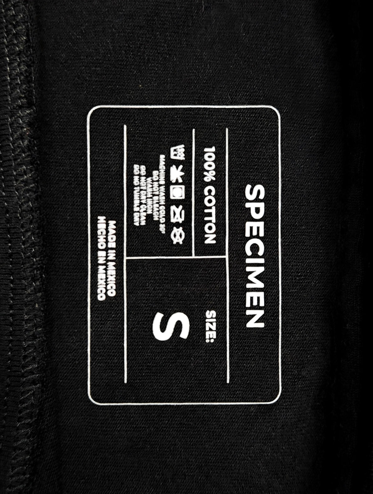 Doers Club black tee printed neck label detail