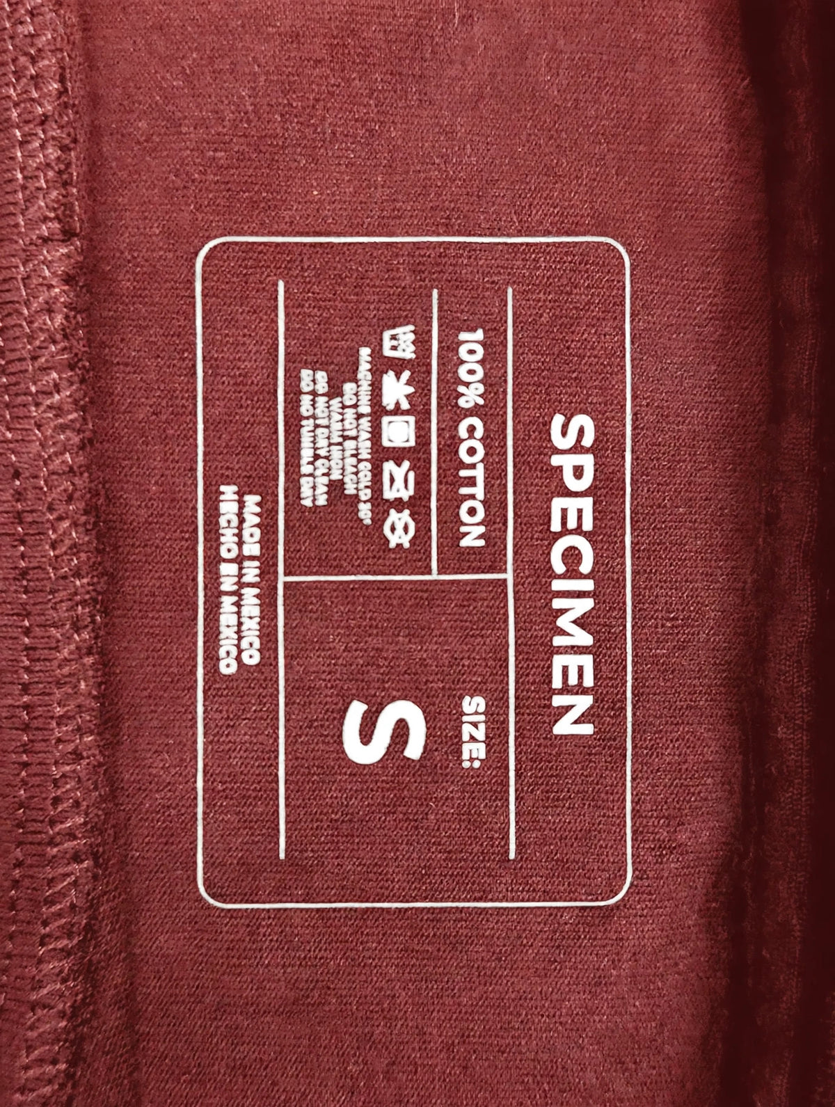 Doers Club red tee printed neck label detail