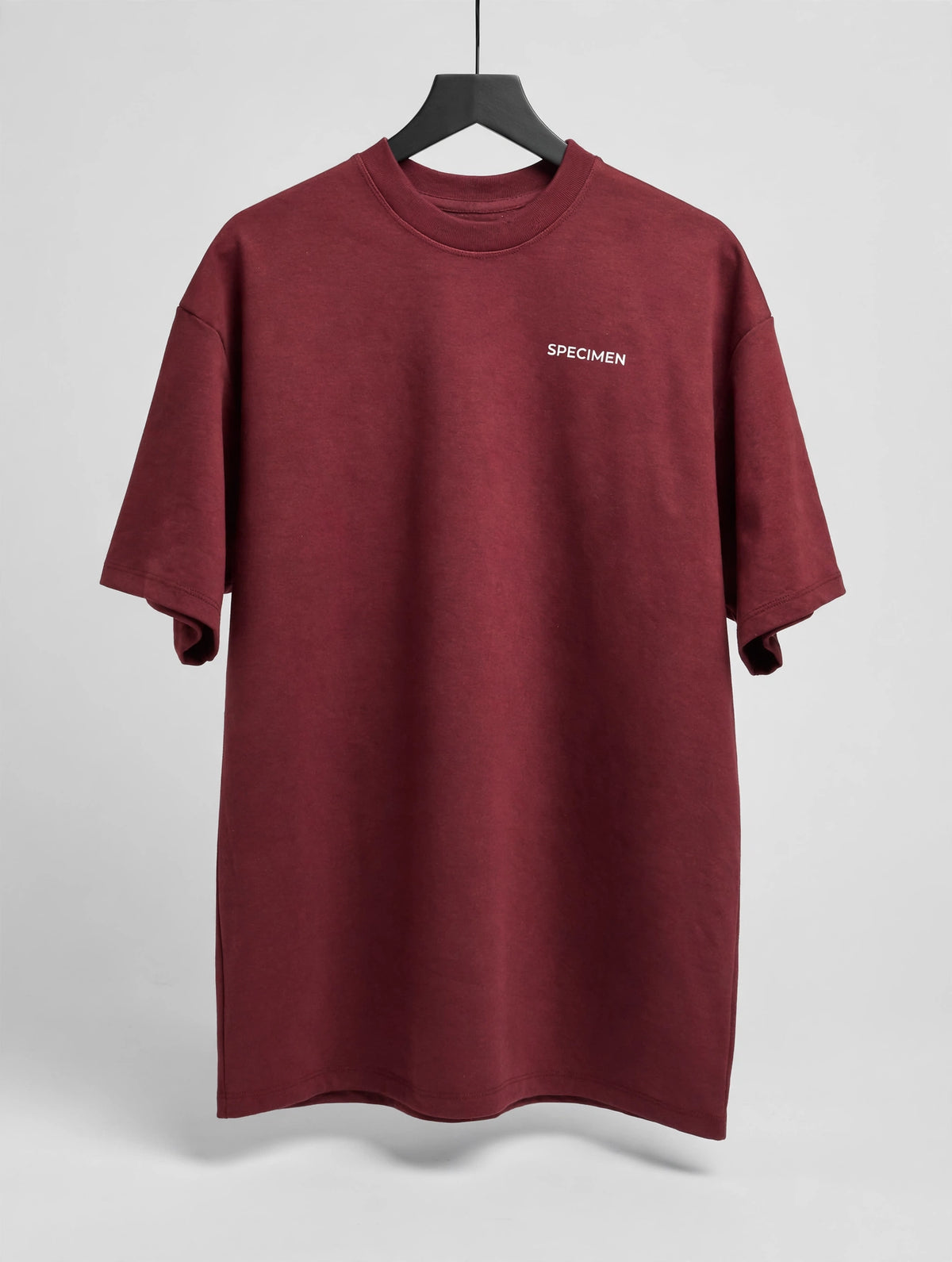Doers Club red tee front on hanger
