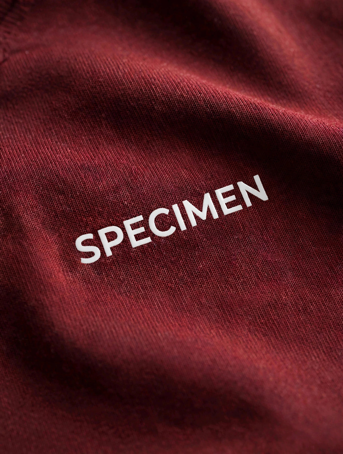 Doers Club red tee cotton texture detail